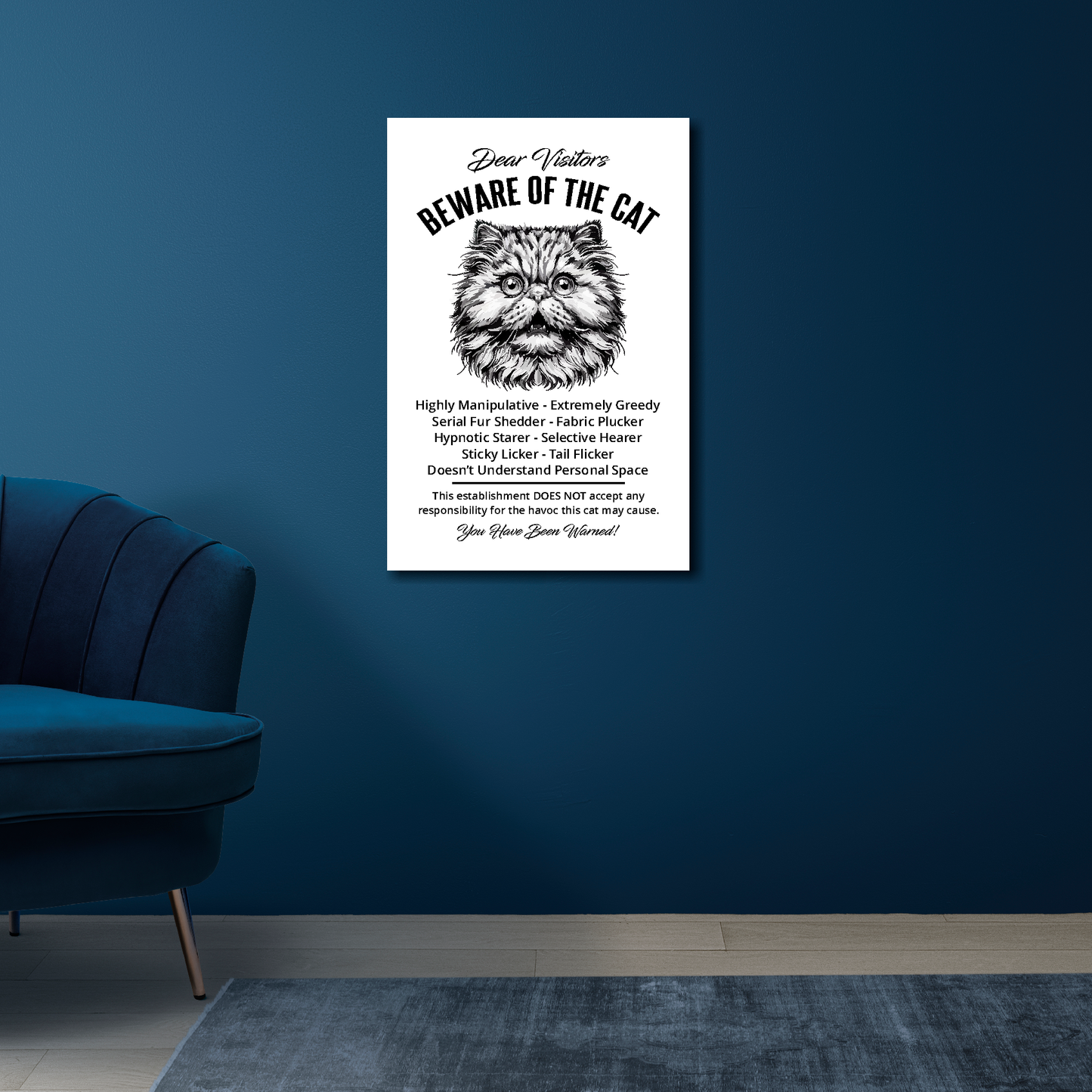 16 inch by 24 inch canvas print of a funny Persian 'Beware of the cat' notice. Mounted on a blue wall above a blue chair.