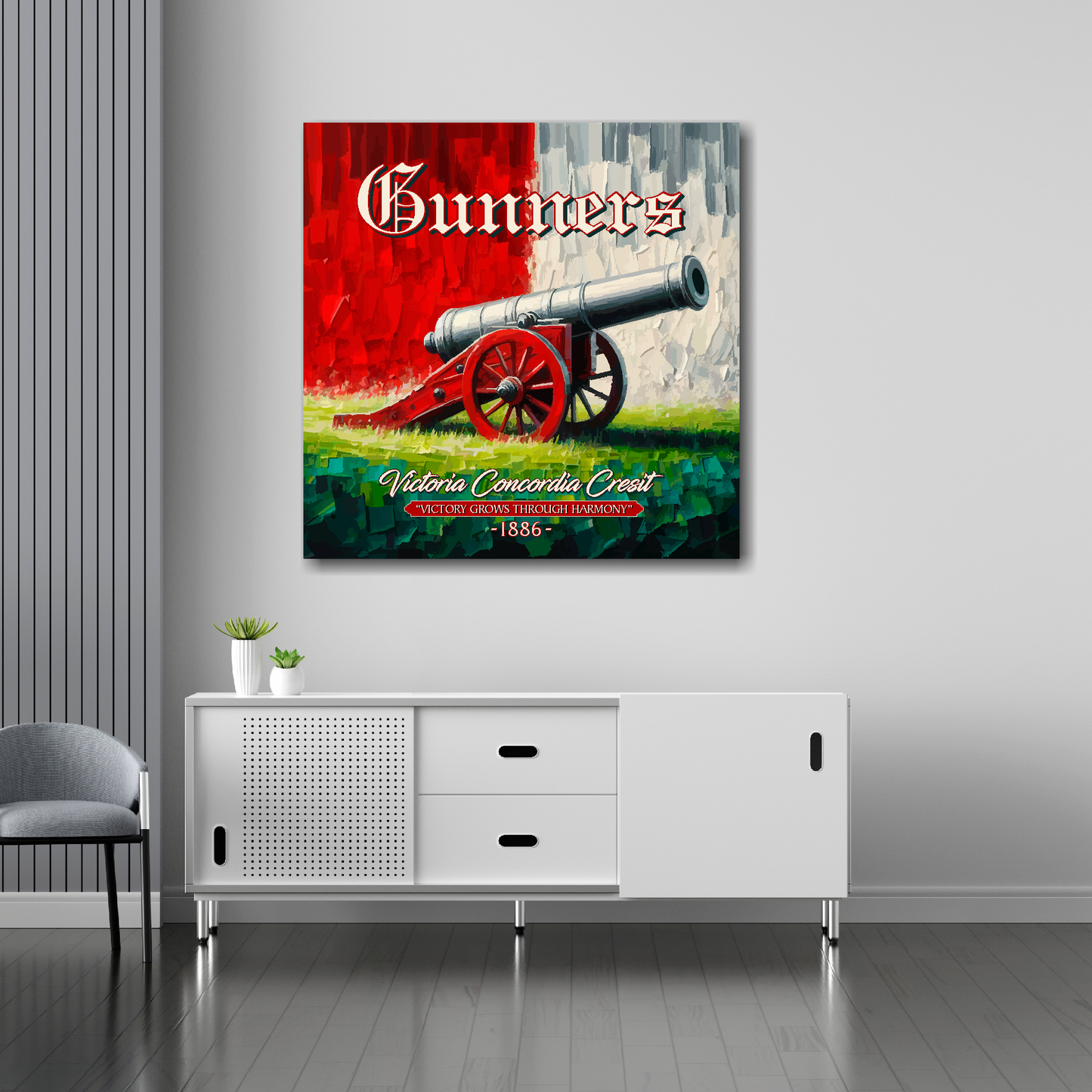 Arsenal inspired canvas wall art. A large cannon centred on a red and white backround. The word Gunners above, Victoria Concordia Cresit, 'Victory Grows Through Harmony' 1886 text below. Mounted on a grey painted wall above a white sideboard.
