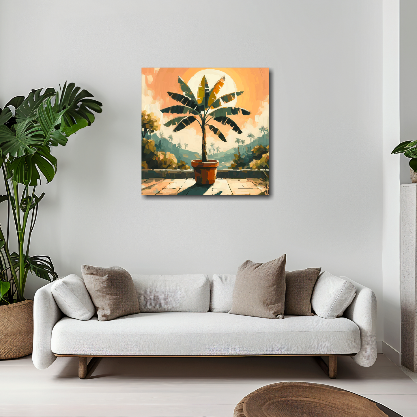 20 inch by 20 inch square canvas featuring a Banana Tree. Mounted on a white wall above a white sofa with decorative pillows.