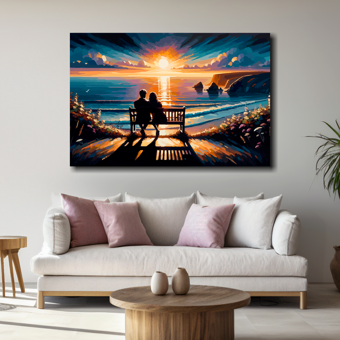 Seascape painting of a couple on a bench at sunset by the sea, above a white sofa with decorative pillows.