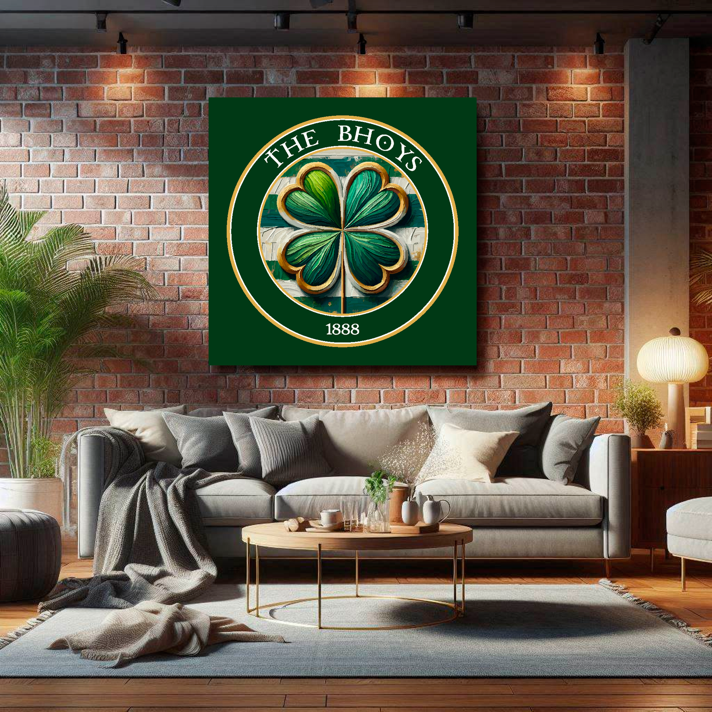 Celtic FC inspired XL canvas, featuring a large clover badge on a green background. Mounted on a brick wall above a grey sofa with decorative cushions.