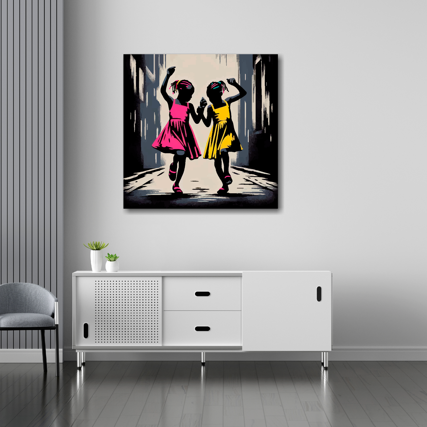 30 inch by 30 inch square canvas featuring a two African girls dancing in the street. Mounted on a white wall above a white sideboard.