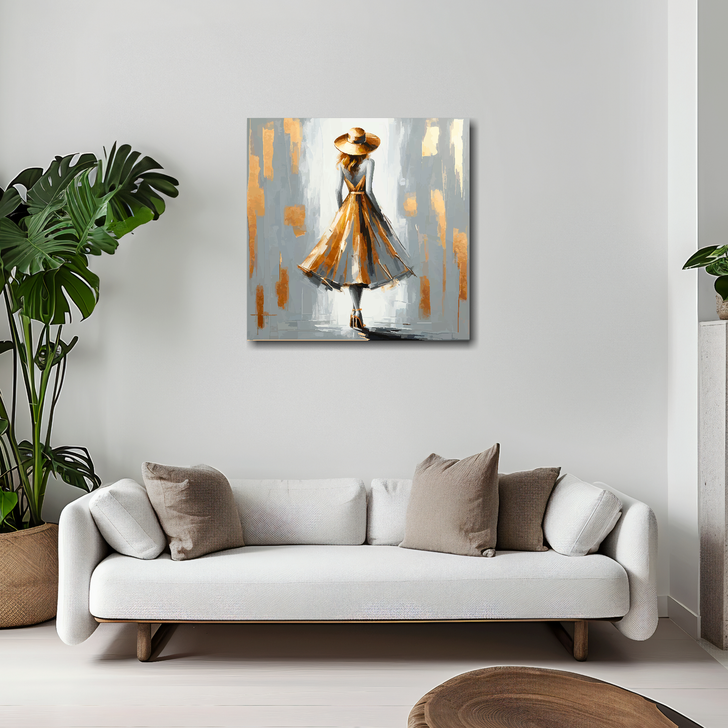 20 inch by 20 inch square canvas featuring a grey and gold fashion dress. Mounted on a white wall above a white sofa with decorative pillows.