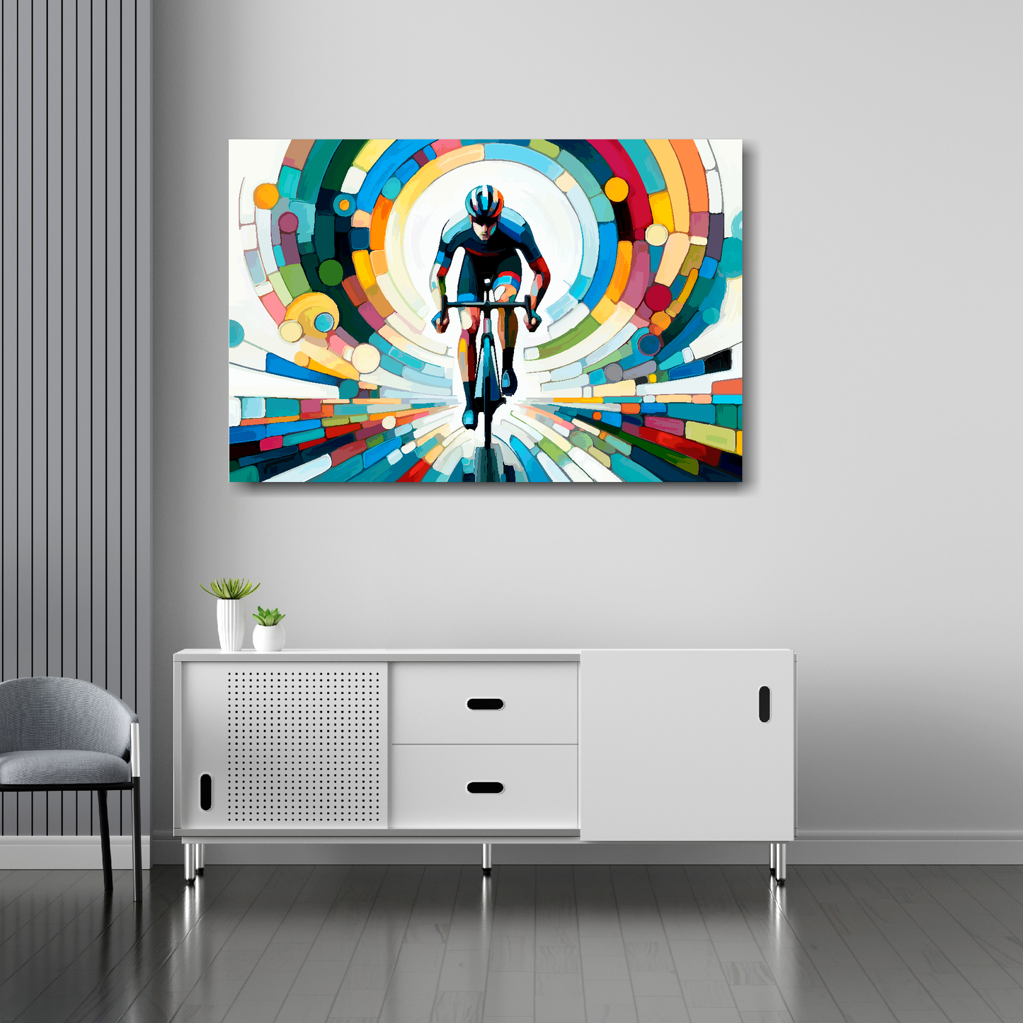 36 inch by 24 inch canvas featuring a colourful cyclist. Mounted on a white wall above a white sideboard.
