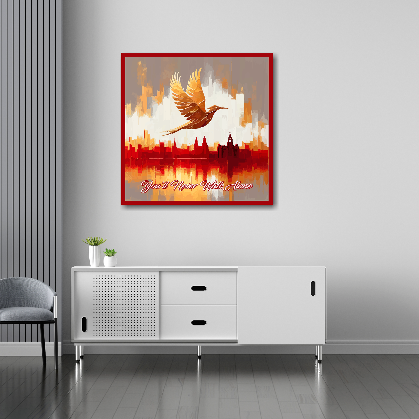 30 inch by 30 inch Liverpool FC inspired canvas, mounted on a living room wall above a white sideboard, featuring a Liver bird flying over a Liverpool skyline with the words 'You'll Never Walk Alone' in red and white.