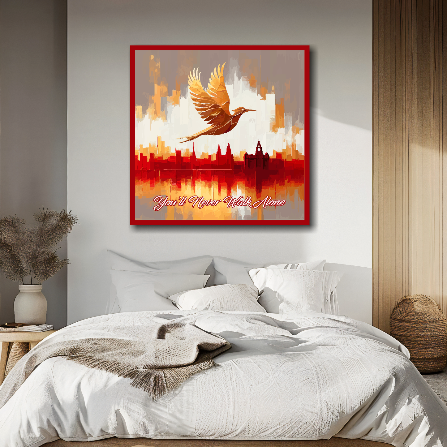 Liverpool FC inspired canvas, mounted on a bedroom wall above a double bed, featuring a Liver bird flying over a Liverpool skyline with the words 'You'll Never Walk Alone' in red and white.