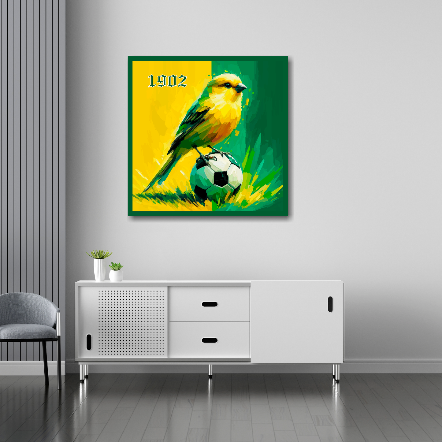 30 inch by 30 inch Norwich City FC inspired canvas, mounted on a white living room wall above a white sideboard, featuring a Canary sitting on a football on a Yellow and Green halved background.