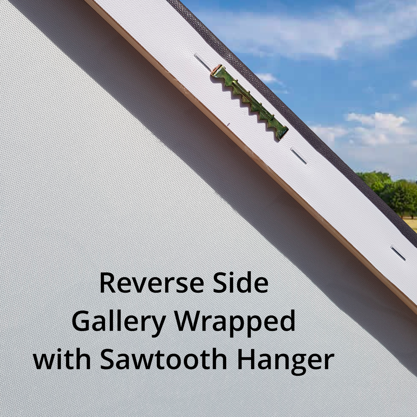 Gallery wrapped canvas with a sawtooth hanger on the reverse side, set against a clear blue sky.