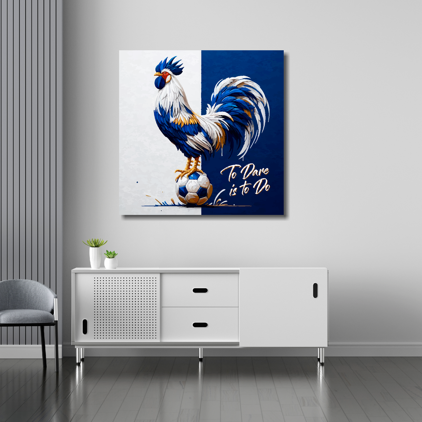Tottenham Hotspur inspired canvas art. A colourful cockeral stands on a football on a white and navy blue halved background. Text saying, 'To Dare is to Do' in the bottom right hand corner. Hanging on a lounge brick wall above a white sideboard.
