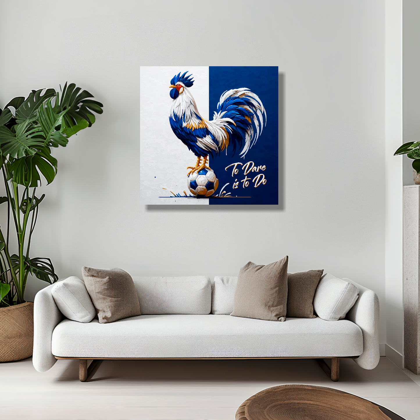 Tottenham Hotspur inspired canvas art. A colourful cockeral stands on a football on a white and navy blue halved background. Text saying, 'To Dare is to Do' in the bottom right hand corner. Hanging on a lounge wall above a white sofa.