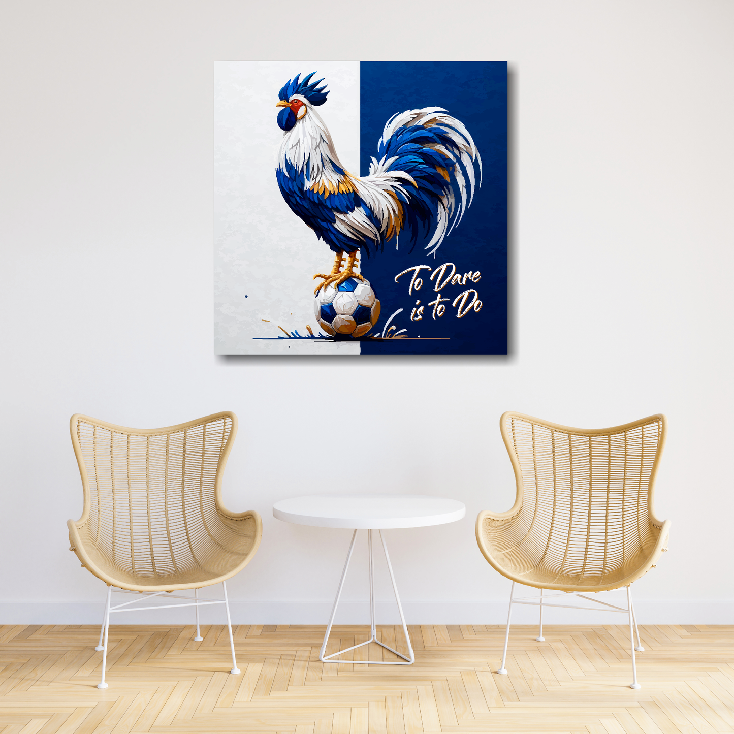 Tottenham Hotspur inspired canvas art. A colourful cockeral stands on a football on a white and navy blue halved background. Text saying, 'To Dare is to Do' in the bottom right hand corner. Hanging on a white wall above two chairs and a table.