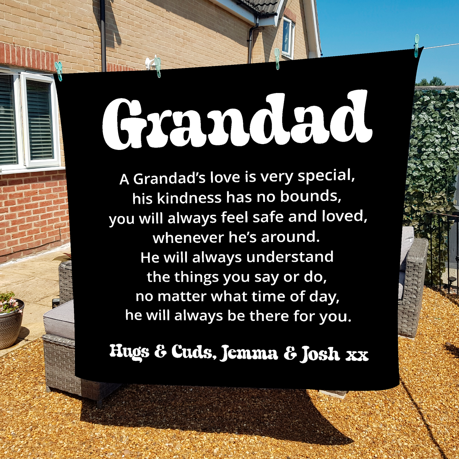 Large fleece blanket with white text about a grandad's love, hanging outdoors on a washing line.