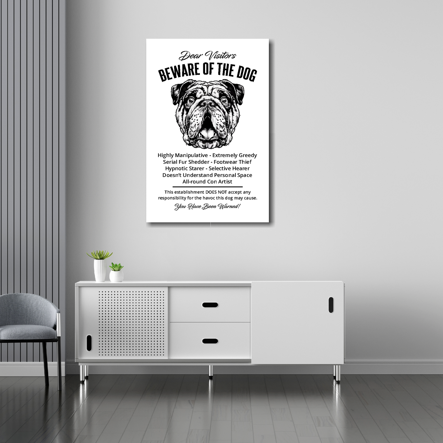 20 inch by 30 inch canvas print of a funny Bulldog 'Beware of the Dog' notice. Mounted on a gray wall above a white sideboard.
