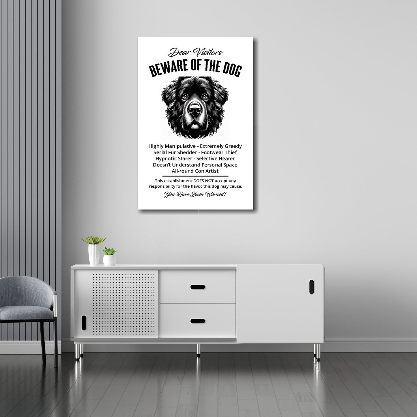 20 inch by 30 inch canvas print of a funny Newfoundland 'Beware of the Dog' notice. Mounted on a gray wall above a white sideboard.
