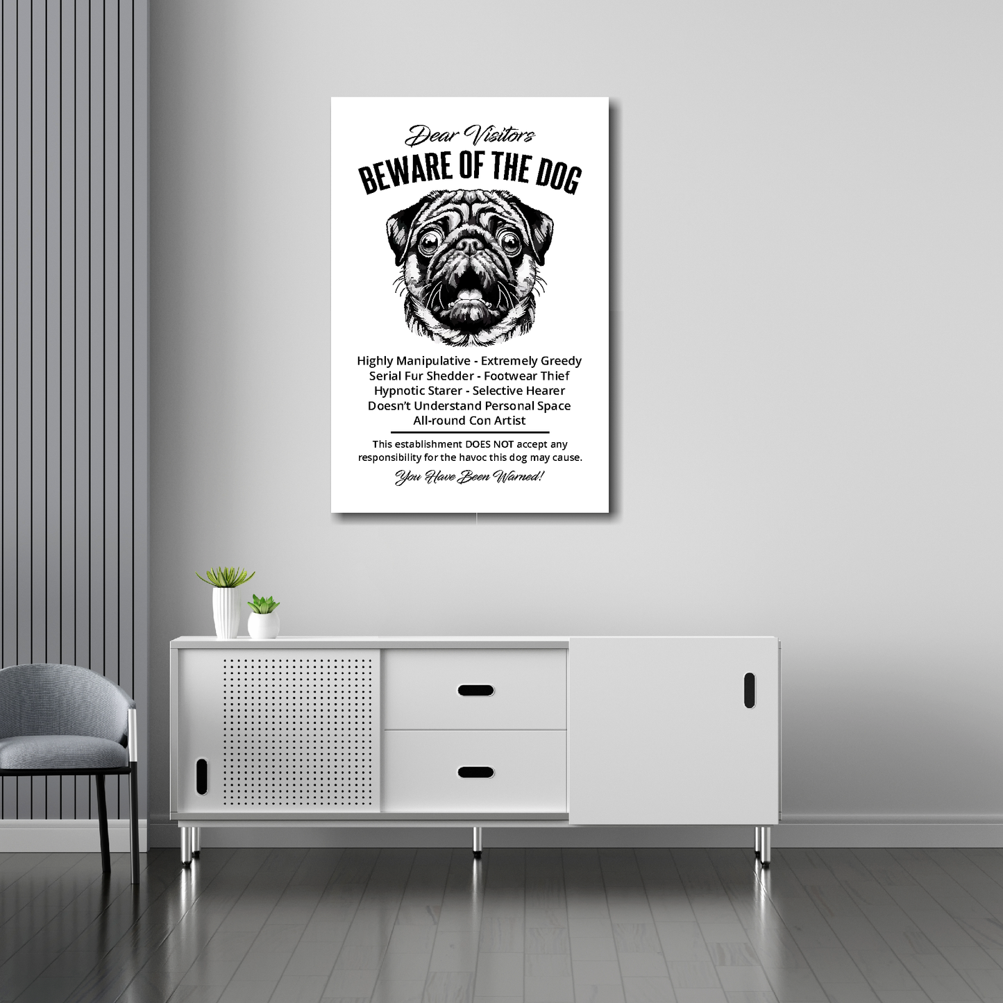 20 inch by 30 inch canvas print of a funny Pug 'Beware of the Dog' notice. Mounted on a gray wall above a white sideboard.