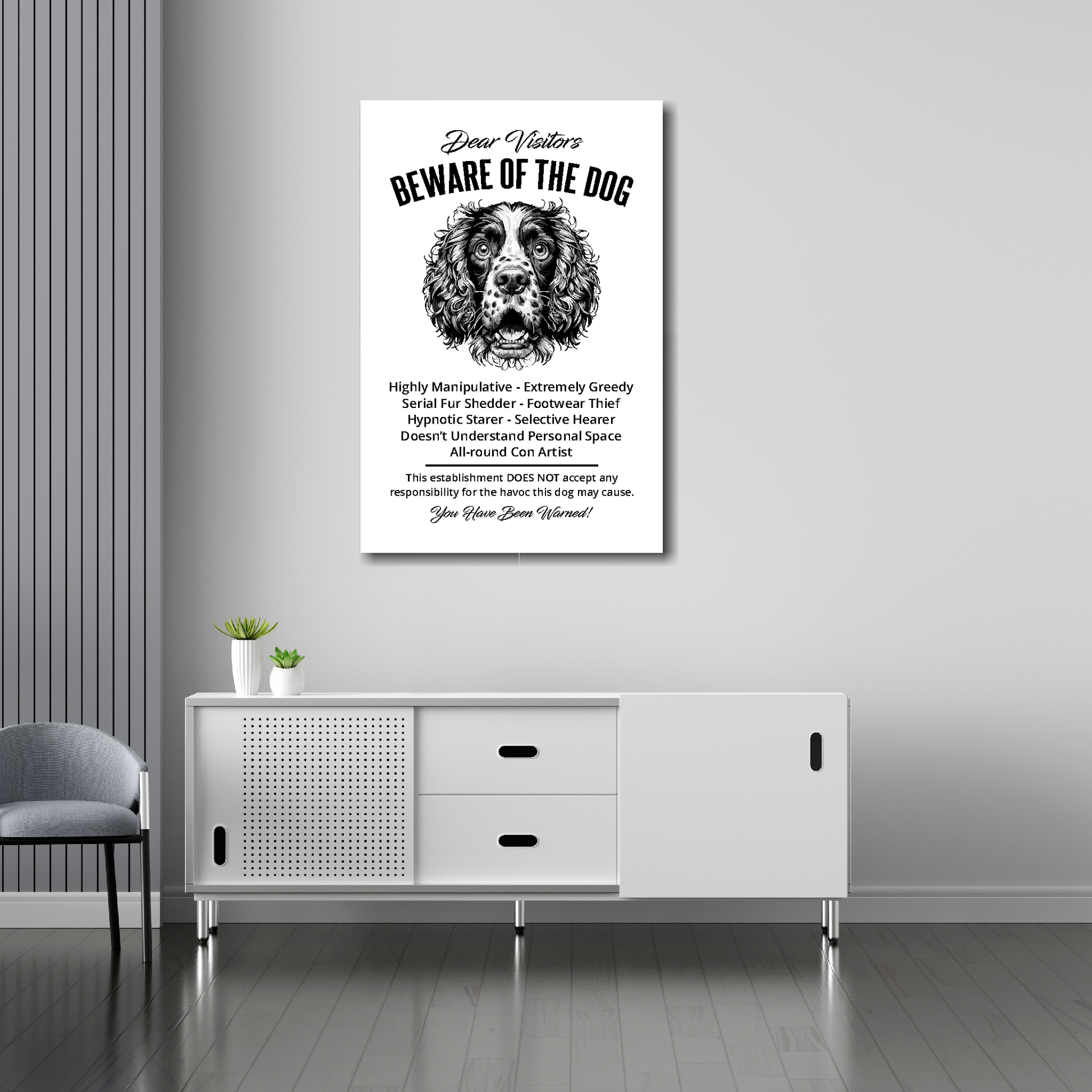 20 inch by 30 inch canvas print of a funny Springer Spaniel 'Beware of the Dog' notice. Mounted on a gray wall above a white sideboard.