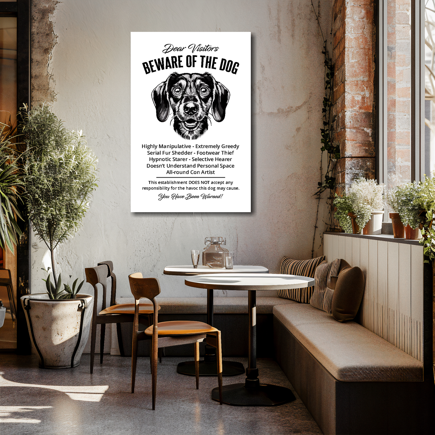 24 inch by 36 inch canvas print of a funny Dachshund 'Beware of the Dog' notice. Mounted on a cream cafe wall above tables and chairs.