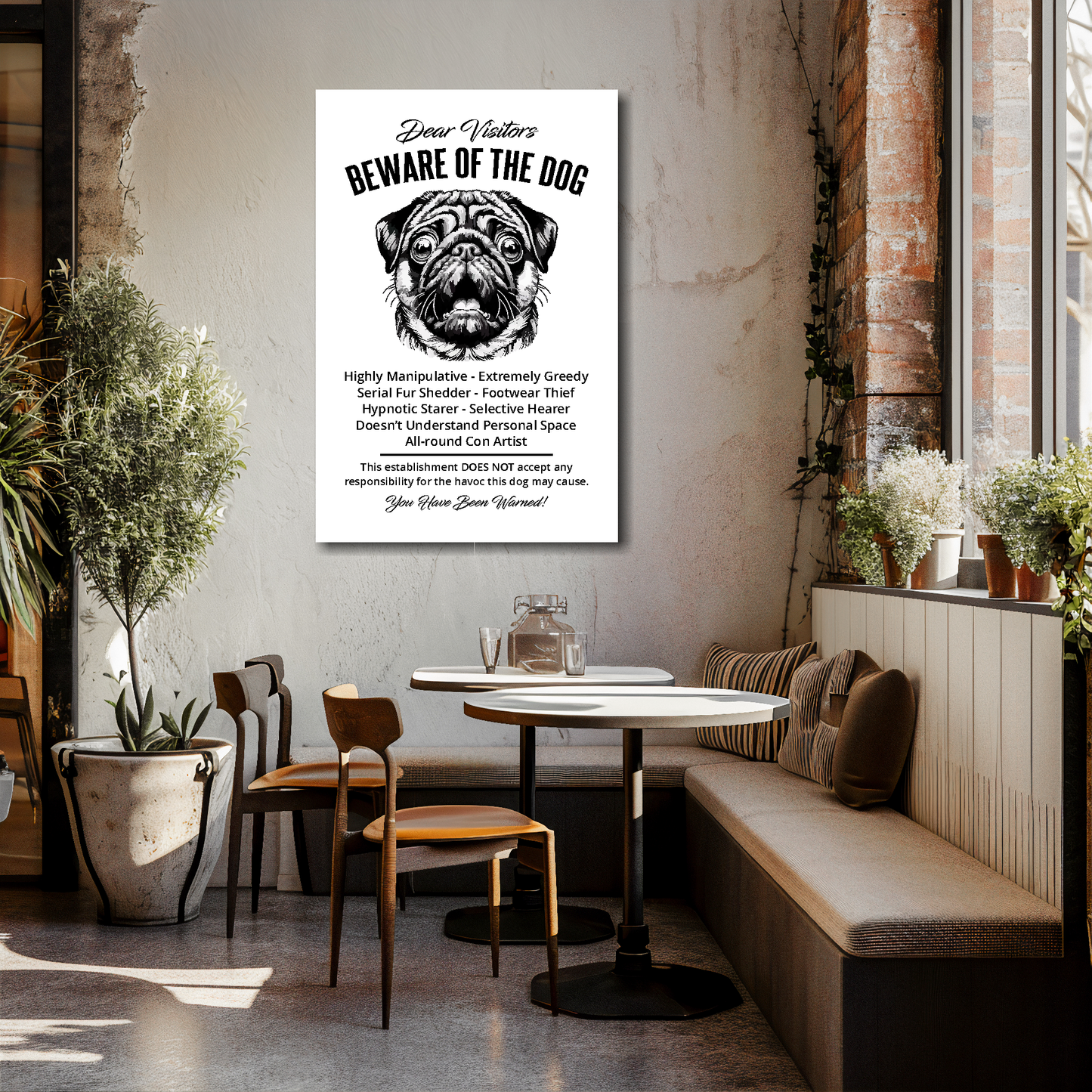 24 inch by 36 inch canvas print of a funny Pug 'Beware of the Dog' notice. Mounted on a cream cafe wall above talbes and chairs.