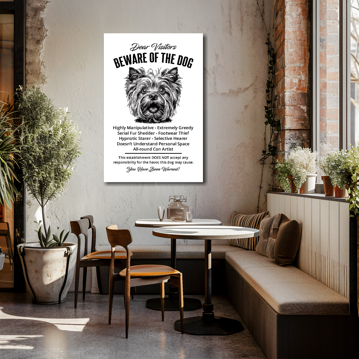 24 inch by 36 inch canvas print of a funny Yorkshire Terrier 'Beware of the Dog' notice. Mounted on a cream cafe wall above tables and chairs.