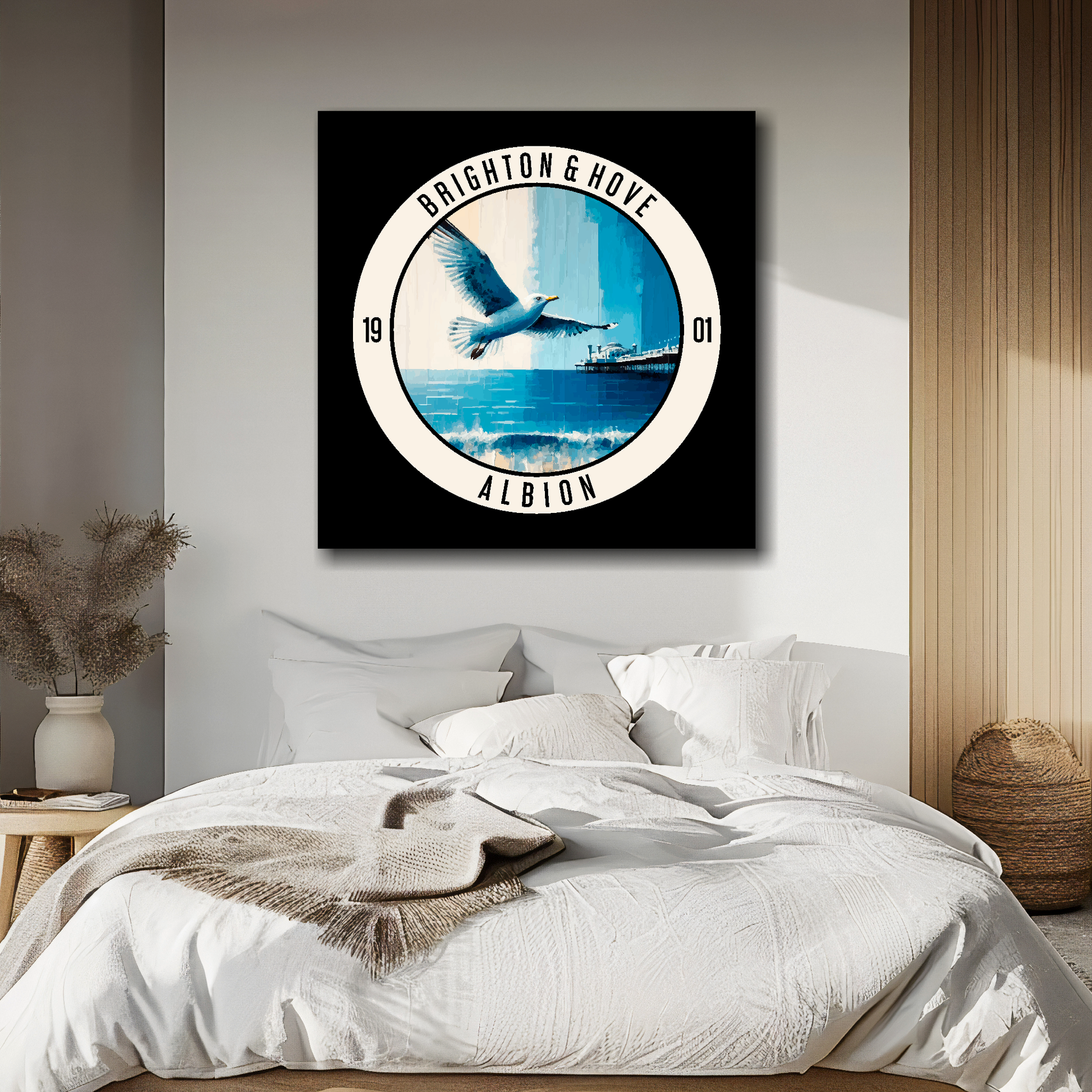 Brighton FC inspired canvas, featuring a large seagull, beach and pier on black background. Mounted on a white wall above a double bed.