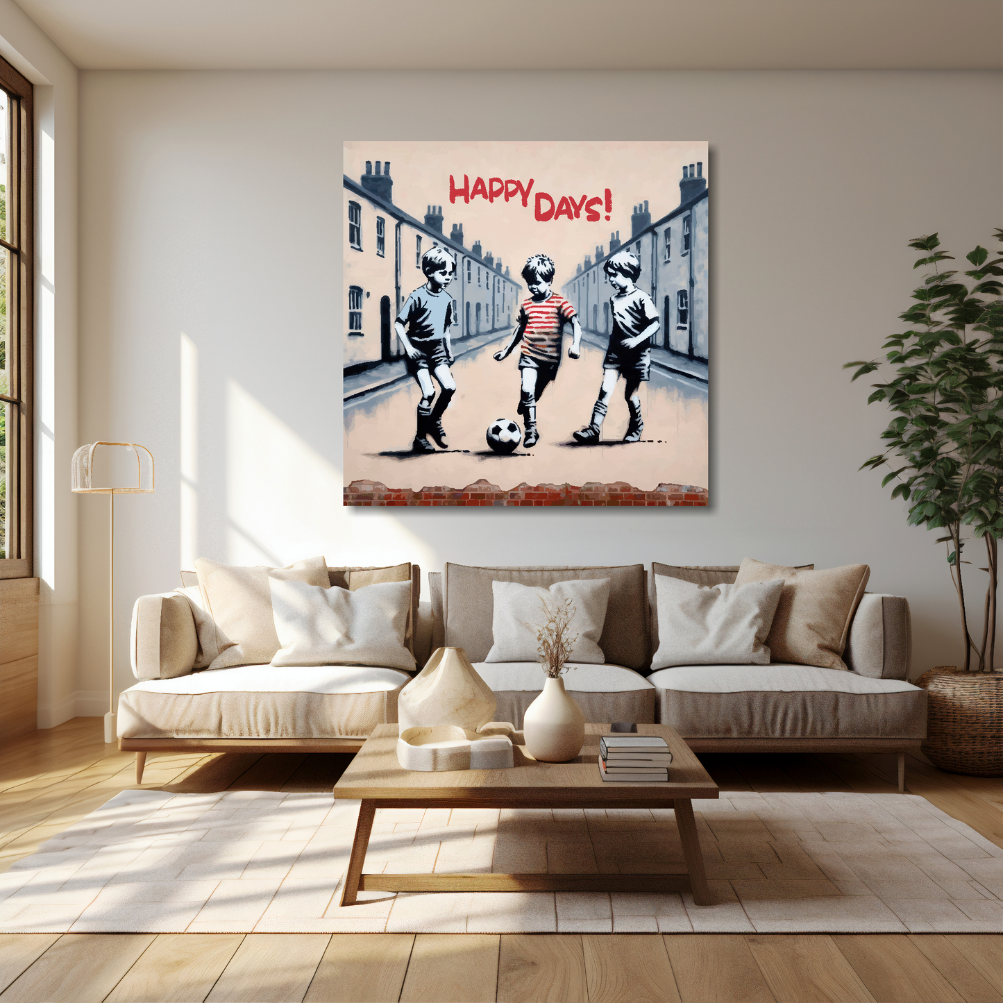 40 inch by 40 inch square canvas featuring three young boys playing football in the street, text at the top saying...'Happy Days'. Mounted on a cream wall above a cream sofa with decorative pillows.