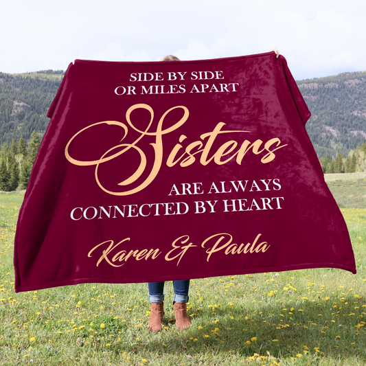 A woman holding up a 150x150 cm personalised fleece blanket. Made in the UK.